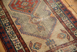Vintage Serab runner's geometric central medallion with serrated mahi-mahi motifs and pile wear.