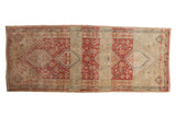 Distressed Shiraz runner with geometric central medallions in raspberry, ivory, and pale gold tones.