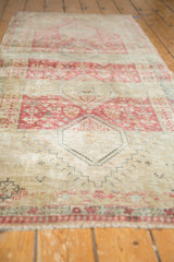 The time-softened pile and stepped contour of a raspberry medallion on a vintage Shiraz runner.