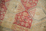 Detail of the distressed pile, showing even wear to the knot heads and dusty raspberry motifs.