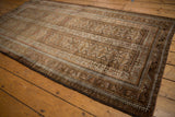 Distressed Vintage Belouch rug, geometric tribal patterns, muted bronze and slate blue.