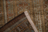 Distressed Belouch rug pile with visible foundation, hand-knotted reverse, and selvage.