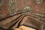 Vintage distressed Belouch rug with geometric guls, terra cotta rust hues, and even pile wear.