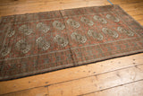 Vintage distressed Belouch rug corner detail, highlighting the main border's geometric patterns and worn texture.