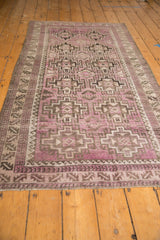 Distressed Belouch runner detail with purple, charcoal geometric medallions and borders.
