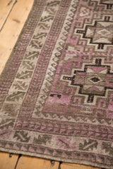 Distressed geometric pattern in muted purple and charcoal on the Belouch runner.