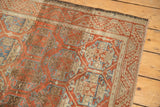 Distressed Belouch rug with madder red, sky blue lattice floral motif and softened pile.