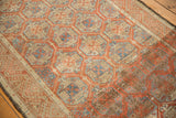 Distressed Belouch rug's lattice and floral motifs in madder red and sky blue.