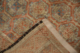 Distressed Belouch rug pile and hand-knotted foundation, with geometric motifs.
