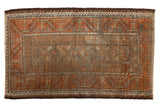 Distressed vintage Belouch rug featuring muted floral guls, geometric border in earthy browns, rust, and soft blue, 2'10
