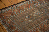 Distressed vintage Belouch rug texture, with muted rust, coffee brown, and sky blue floral guls.