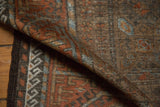 Vintage distressed Belouch rug pile texture with reciprocating wave border, coffee and rust hues.