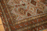 Distressed Belouch runner displaying rich rust, slate blue, bronze floral lattice with serrated leaves.