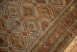 Distressed vintage Belouch runner showing side selvage, geometric borders, and rich patina.