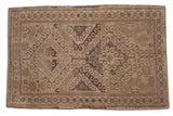 Vintage Distressed Belouch rug with double medallion, rams horn, and starburst motifs in muted beige and charcoal tones, 2'11