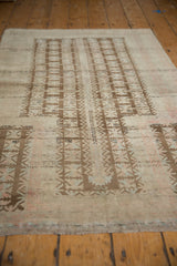 Primitive coffee brown tree of life motif on distressed vintage Belouch rug.