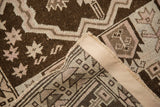 Intricate hand-knotted construction, brown and beige geometric patterns, plus side cord selvage of a Belouch rug.