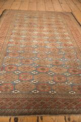 Distressed vintage Belouch rug's Mina Khani floral pattern, with dusty denim blue and madder root.