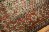 Wide madder root red border contrasting with the silver floral field on a distressed Belouch rug.