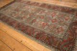 Distressed Belouch runner with repeating starburst floral field and hook and latch border.