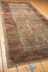 Distressed Belouch runner showing textural faded starburst patterns in slate blue and terracotta.