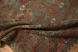 Distressed Belouch rug with slate blue, terracotta geometric border and starburst field.