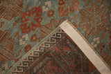Distressed slate blue and terracotta starburst pattern with hand-knotted Belouch rug reverse.