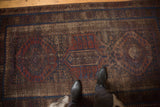Antique Timuri Belouch rug with central medallion, visible foundation, and rich jewel tones.