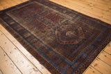 Early 20th century distressed Belouch rug corner, worn coffee brown field, sapphire border.