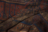 Distressed texture of antique Belouch rug with madder red and sapphire blue pile wear.