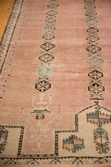 Distressed Belouch rug detail: dusty rose abrash, ivory planters, charcoal and sky blue medallions.