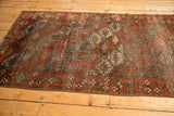 Distressed Belouch rug border, geometric guls and vine motifs in madder red and slate blue.