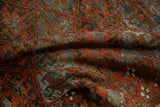 Distressed pile texture of vintage Belouch rug with madder red, slate blue geometric forms.
