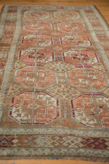 Textured distressed Belouch runner showing blush Bokhara guls and faded coffee brown rams horn motifs.