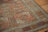 Texture of distressed Vintage Belouch rug showing worn Bokhara style guls and rams horn motifs.
