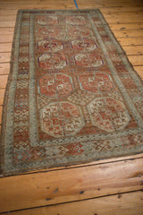 Distressed vintage Belouch runner's worn pile, short fringe, and geometric patterns.