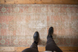 Distressed Oushak runner with faded blush, dusty rose, and visible foundation.