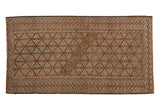 Distressed vintage Belouch runner rug with faded geometric lattice, brown, blue, and ivory tones.