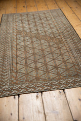 Distressed Belouch rug runner's lattice, geometric plant motifs, and distinct wave border.