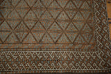 Distressed Belouch runner border with ivory wave motif and geometric patterns in brown and pale blue.