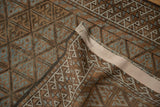 Vintage distressed Belouch runner with geometric lattice, visible wear, and intact side selvage.