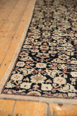 Intricate Herati motif of a distressed vintage Karabagh runner in navy, ivory, and rose.