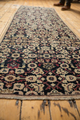 Distressed vintage Karabagh runner, intricate Herati motif in navy, ivory, and rose tones.