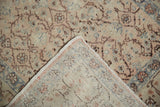 Distressed floral pile and visible hand-knotted reverse of a vintage Kayseri rug.