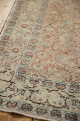 Textural distressed pile showcasing intricate faded floral cross-sections and scrolling vinery.