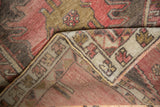 Distressed vintage Oushak rug pile with dusty rose, bronze, charcoal, and tight foundation.