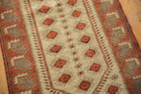 Distressed vintage Oushak runner detail, ivory field with raspberry pomegranate motifs and stylized border.