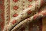 Distressed Oushak rug texture in ivory and dusty raspberry, highlighting varying pile and knot heads.