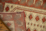 Vintage Distressed Oushak runner's hand-knotted reverse and ivory pile with cochineal red motifs.