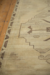 Vintage Distressed Oushak runner with primitive beige and charcoal geometric pattern on abrashed field.